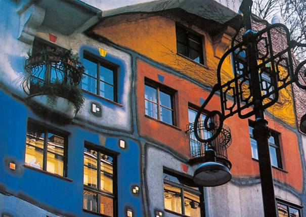 A photo of Hundertwasserhaus work. A colorful building.